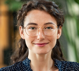 Young adult woman with glasses looking at camera