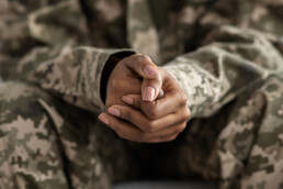 soldier clasping hands stressed